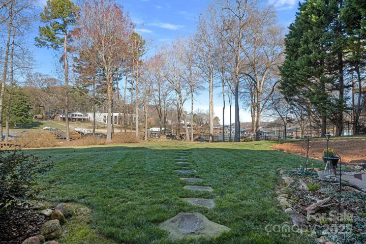 Stepping-stone pathway to fire pit and floating dock, accessed from walk-out basement