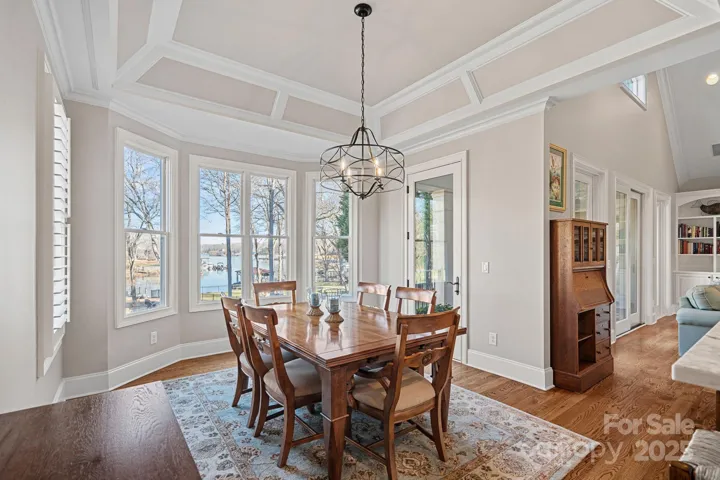 Beautiful, formal dining room with custom architectural details and lake views.