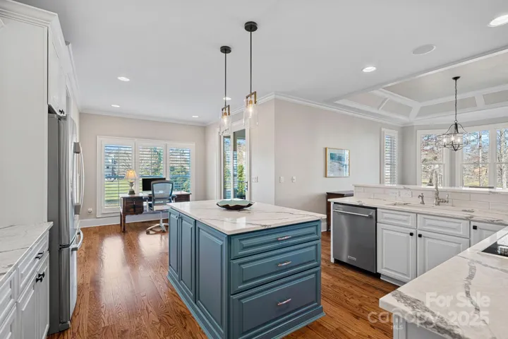 Newly renovated gourmet kitchen with SS appliances, quartz countertops, large island, and breakfast bar....open to the dining and living areas with lake views!