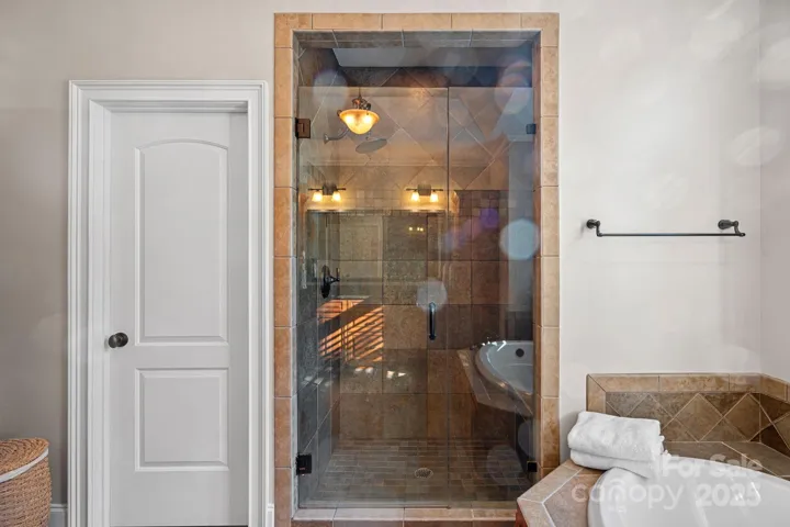 rimary ensuite with large, walk-in shower, garden tub, beautiful custom cabinetry