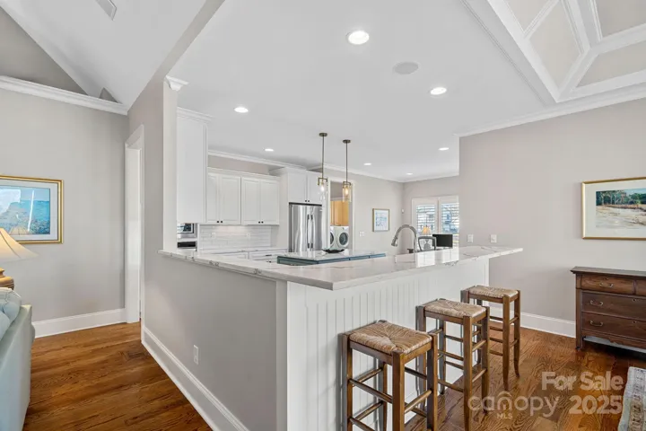 Newly renovated gourmet kitchen with SS appliances, quartz countertops, large island, and breakfast bar....open to the dining and living areas with lake views!