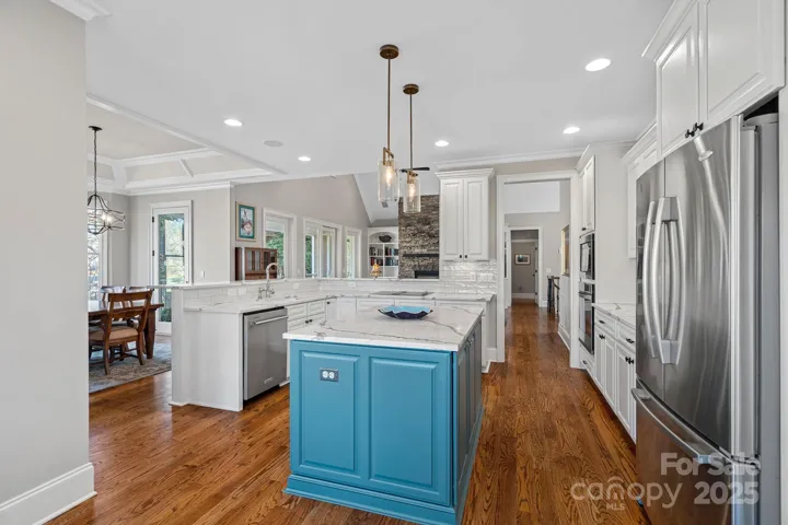 Newly renovated gourmet kitchen with SS appliances, quartz countertops, large island, and breakfast bar....open to the dining and living areas with lake views!