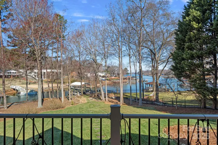 Covered balcony with lake views, accessed from either living room, dining room, or primary bedroom!