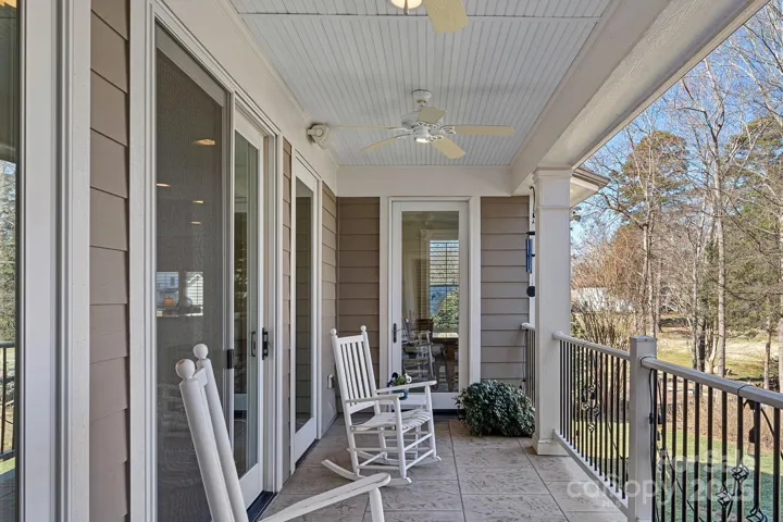 Covered balcony with lake views, accessed from either living room, dining room, or primary bedroom!