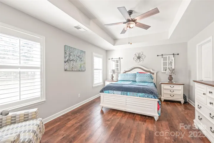 Primary bedroom on the main floor with tray ceiling