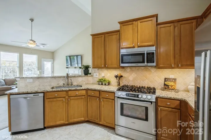 Kitchen with Granite countertops and tile backsplash