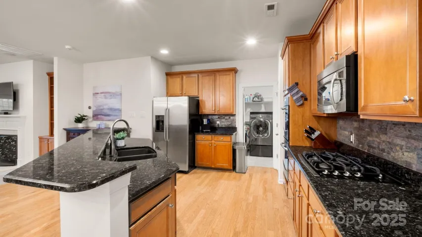 Large upgraded chefs kitchen with 42" cabinets, upgraded appliances and huge island with bar seating!