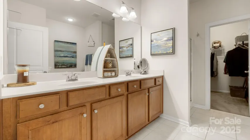 Primary ensuite has double sinks and excellent storage, leads to large walk-in primary closet