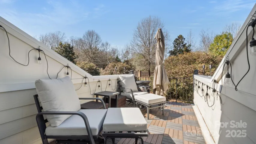 Fabulous rooftop terrace with teak decking overlooks gorgeous landscaping