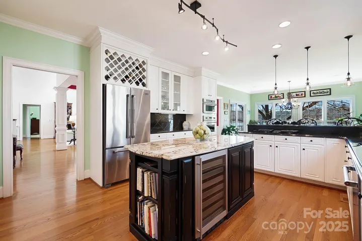 Engage your inner chef in the eat-in gourmet kitchen, equipped w/ ss appliances, gas cooktop, wall oven, Viking oven, center island, breakfast bar, wine cooler, & 2 pantries with the lake view as your backdrop