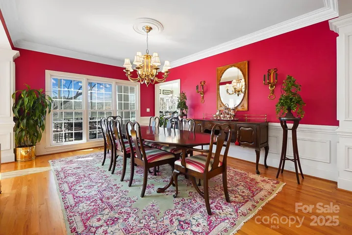 The formal dining room with wainscoting is perfect for elegant dinner parties or casual gatherings
