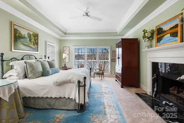 Retreat to the luxurious primary suite on the main floor w/ fireplace, built-in cabinetry, and spa-like bathroom offers a sanctuary for relaxation and rejuvenation