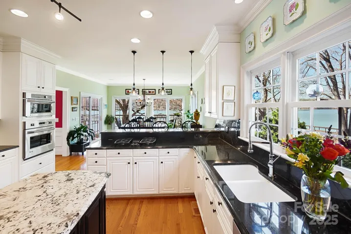 A spacious center island, breakfast bar, & 2 pantries provide ample space for culinary creations, all while enjoying the captivating lake views