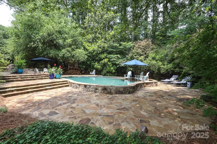 Pool, spa and expansive flagstone pool deck Main house