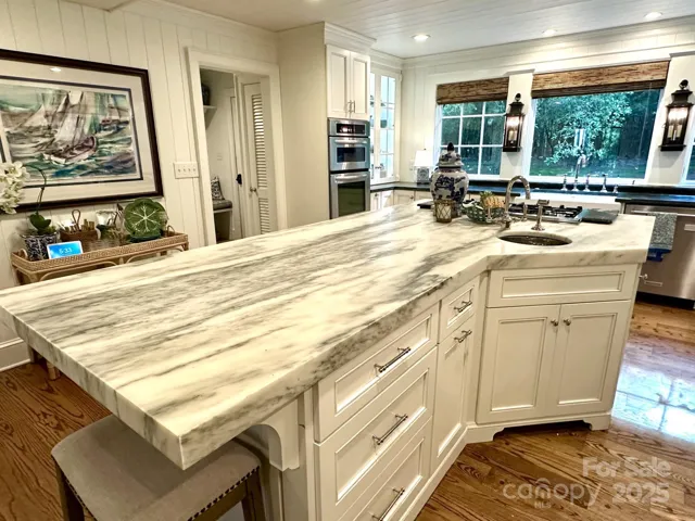 Kitchen island with prep sink and second trash roll out