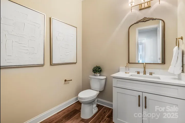 Designer powder room with elegant finishes and custom vanity