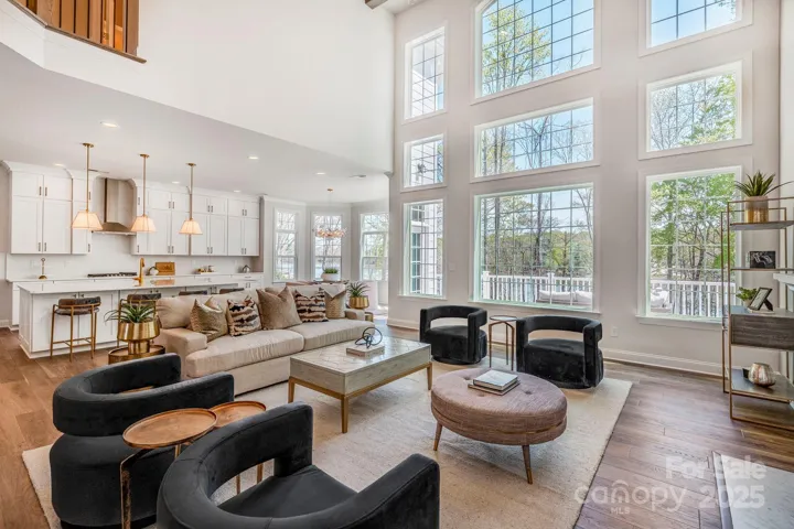 Open concept living room filled with natural light and soaring ceilings.