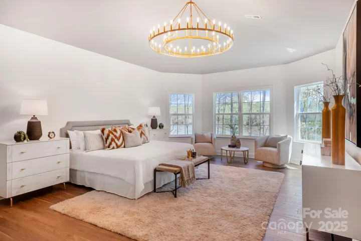 Luxurious primary bedroom with cathedral ceilings and spa-like ambiance.