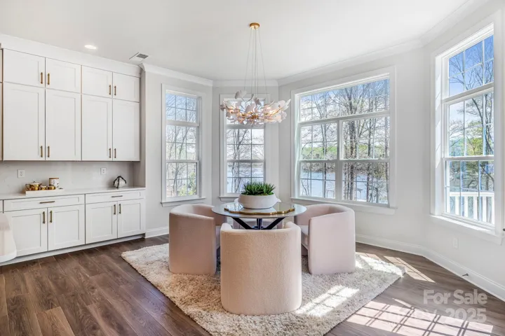 Breakfast/sunroom area offering panoramic water views and casual dining vibes