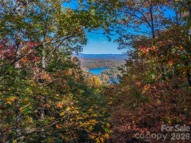 The property features many homesite options with long-range views over Lake Toxaway. Autumn view example.