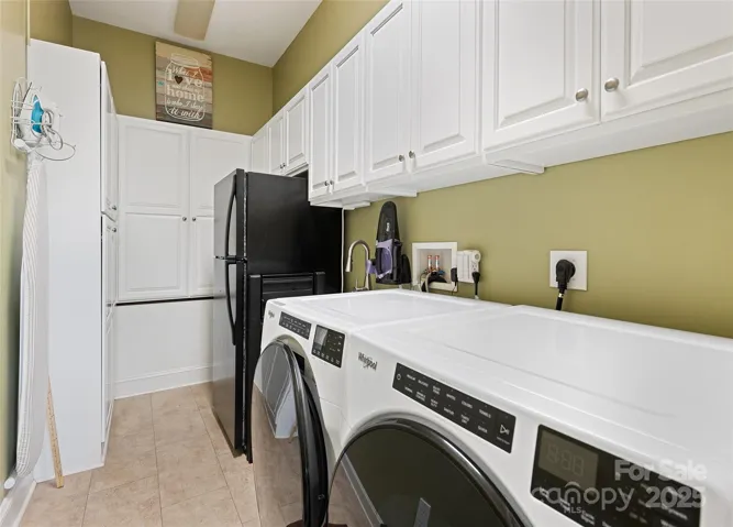 lauindry room with lots of built ins