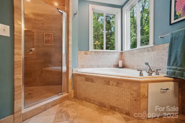Primary bathroom with whirlpool tub and large walk in shower