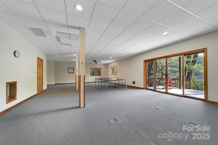 Lower level family room has deck access and view of lake