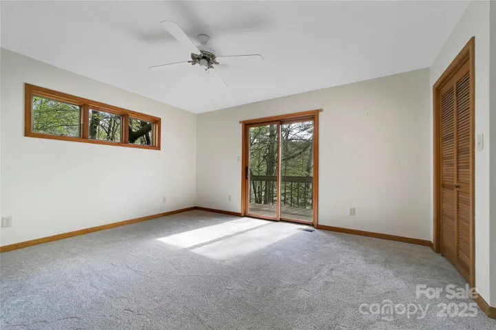 Primary bedroom opens up to deck over looking lake