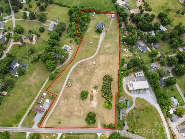 9.32 Acres in Indian Trail with open pastures and a barn.