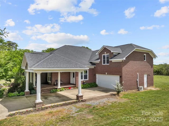 custom, 3 bedroom, 3 bathroom 1.5 story brick home with wrap around porches