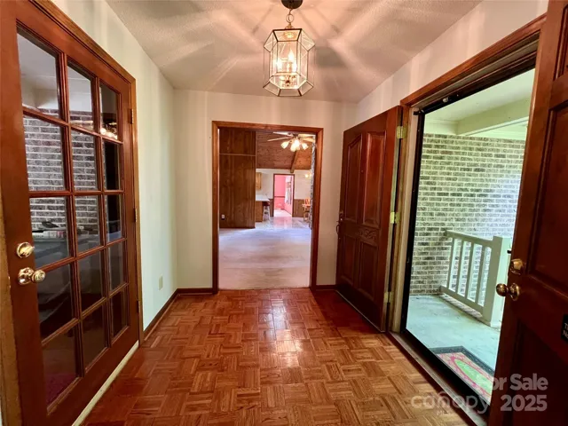 Foyer - Front Door (R), Living Room (C), Back Door to covered porch (L)