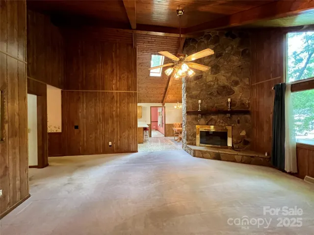 Living Room with Stone Fireplace, Dining Area and Kitchen