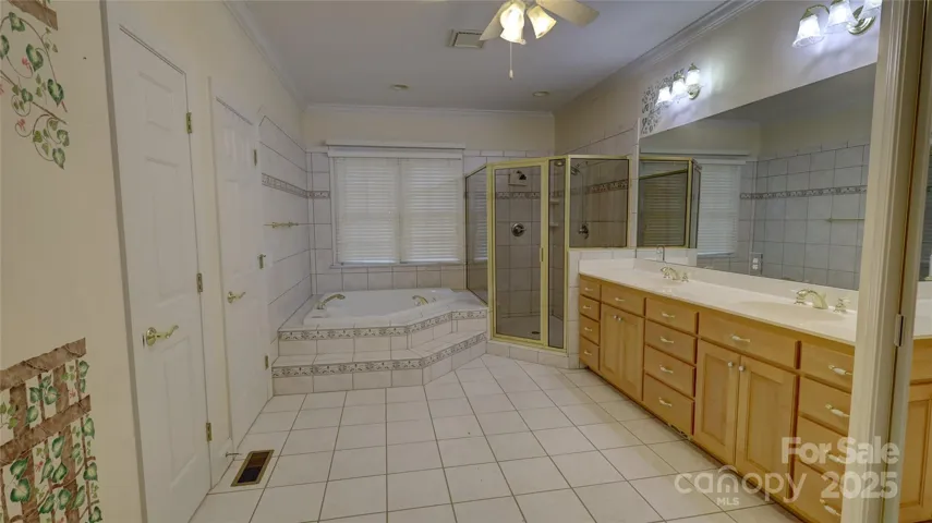 Spacious primary bathroom with two walk in closests, and separate water closet
