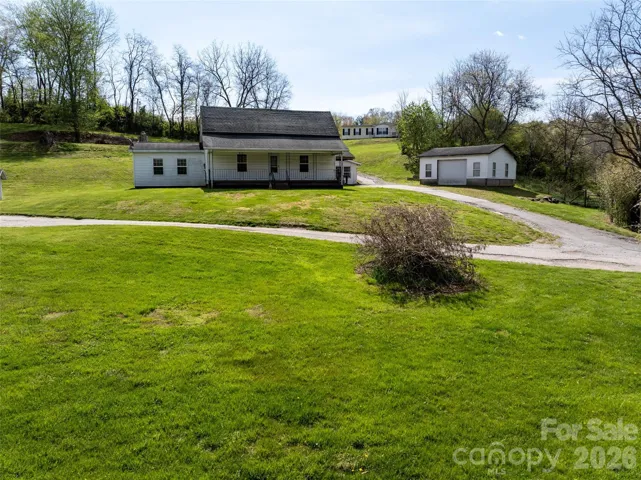 Included with the property is the 1930s farm house, with garage and workshop space, as well as a 2000 sq ft barn and manufactured home on the hill on roughly 3 acres.