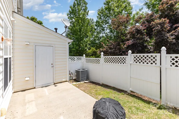 Backyard with privacy fencing and gate, portable fire pit and water heater closet! There is some storage located in the closet as well!