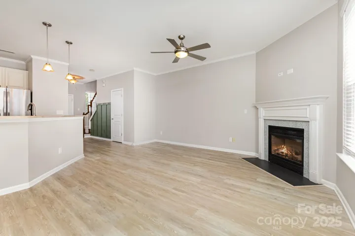 Townhome is beautifully updated with luxury vinyl plank floors, updated fan and fireplace surround!