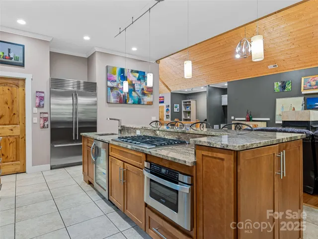 Chef's Kitchen features a Sub-Zero French Door refrigerator, KitchenAid 5-burner gas cooktop as well as a KitchenAid beverage center