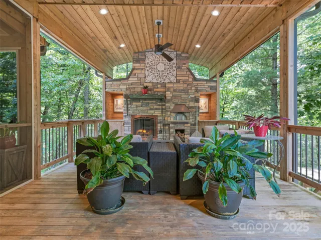 Incredible tree top covered deck makes you feel like you are in a treehouse!