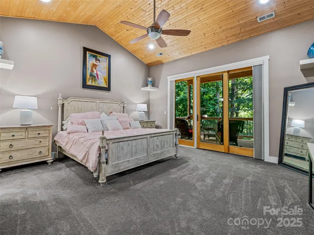Primary bedroom with spacious cathedral ceiling