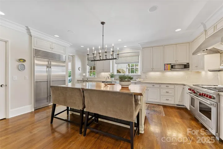 A grand island with a walnut top in the kitchen with bar seating for many!