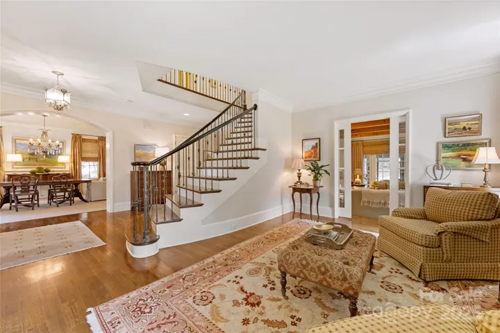 The formal living room has a French door entry into the family room.