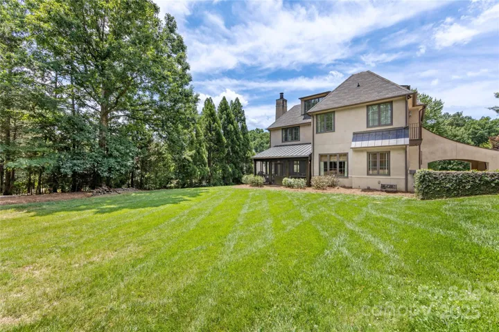 Green, level and lush backyard lined with trees and with room for a pool!