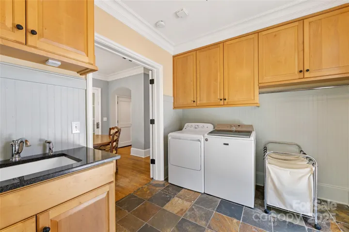 Plenty of cabinetry & a sink in this great laundry room too!