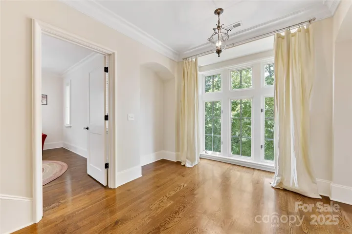 The landing on the second floor features floor to ceiling windows.