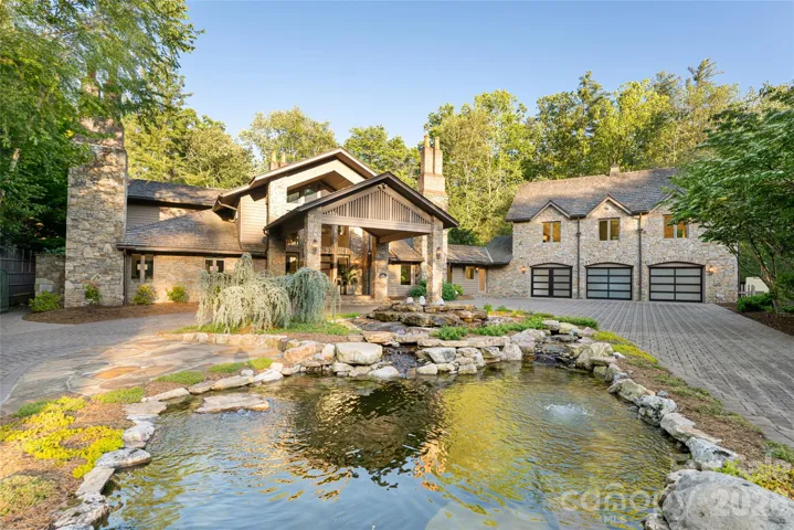 Old-world stone elegance meets modern luxury in this gated, stately residence featuring a circular driveway, grand portico, and tranquil pond.  Main House features a 3 car garage.