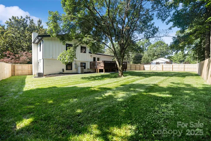 Manicured flat backyard with a tree for shade!