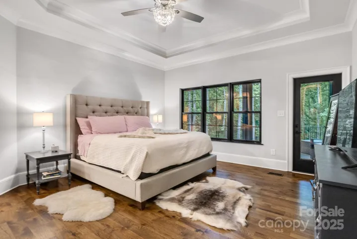 Primary bedroom offers access to the upper terrace.