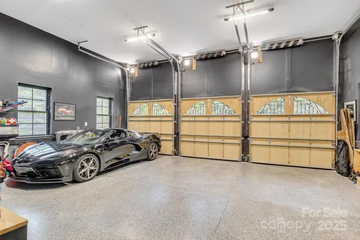 3-Car garage with custom built doors, epoxy flooring and 13.5' ceiling.