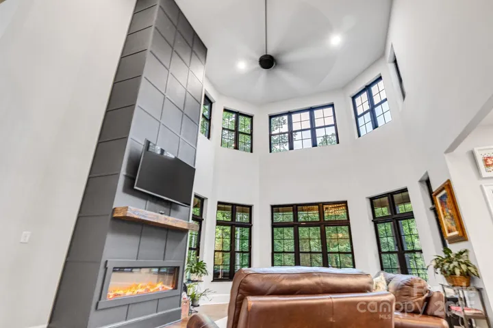 2-Story great room with electric insert fireplace, and tinted windows looking onto the back yard.