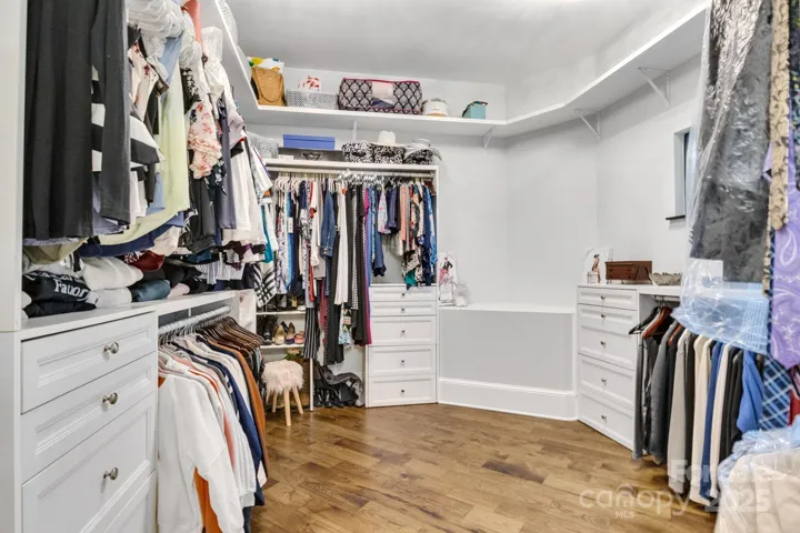 Primary closet provides ample hanging and storage space.
